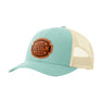 A teal blue trucker-style cap with a tan mesh back and a brown 'your design here' leather patch on the front panel, shown on a plain white background.