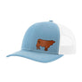 A light blue trucker hat with a white mesh back,and a brown leather cow patch on the front, shown on a plain white background.