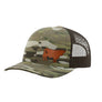 A camouflage trucker hat with a brown mesh back and a brown cow leather patch on the front panel, shown against a plain white background.