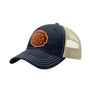 A navy blue trucker-style cap with a tan mesh back and a brown 'your design here' leather patch on the front panel, shown on a plain white background.