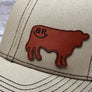 Beige cap with a brown leather cow patch