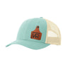 A light blue trucker style hat with a beige mesh back, and a leather cattle tag shaped patch engraved with "wr" on a white background