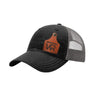 A black trucker style hat with a gray mesh back, and a leather cattle tag shaped patch engraved with "wr" on a white background