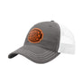 A grey trucker-style cap with a white mesh back and a brown 'your design here' leather patch on the front panel, shown on a plain white background.