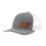 A gray textured trucker hat with white mesh back, with a brown leather cow patch on the front panel, shown against a plain white background.
