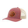 A heathered pink trucker-style cap with a tan mesh back and a brown 'your design here' leather patch on the front panel, shown on a plain white background.