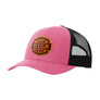 A hot pink trucker-style cap with a black mesh back and a brown 'your design here' leather patch on the front panel, shown on a plain white background.