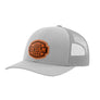 A light gray trucker-style cap with a grey mesh back and a brown 'your design here' leather patch on the front panel, shown on a plain white background.