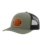 An olive green trucker-style cap with a black mesh back and a brown 'your design here' leather patch on the front panel, shown on a plain white background.
