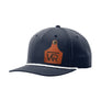 A navy blue retro trucker style hat with a white rope brim and a leather cattle tag shaped patch engraved with "wr" on a white background