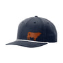A dark navy blue baseball cap with a white braided rope detail along the edge of the brim and a brown cow leather patch on the front, shown against a plain white background.
