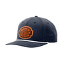 A navy blue baseball cap with a curved brim, featuring a white rope detail along the edge of the brim and a customizable brown patch on the front that reads 'YOUR DESIGN HERE'.
